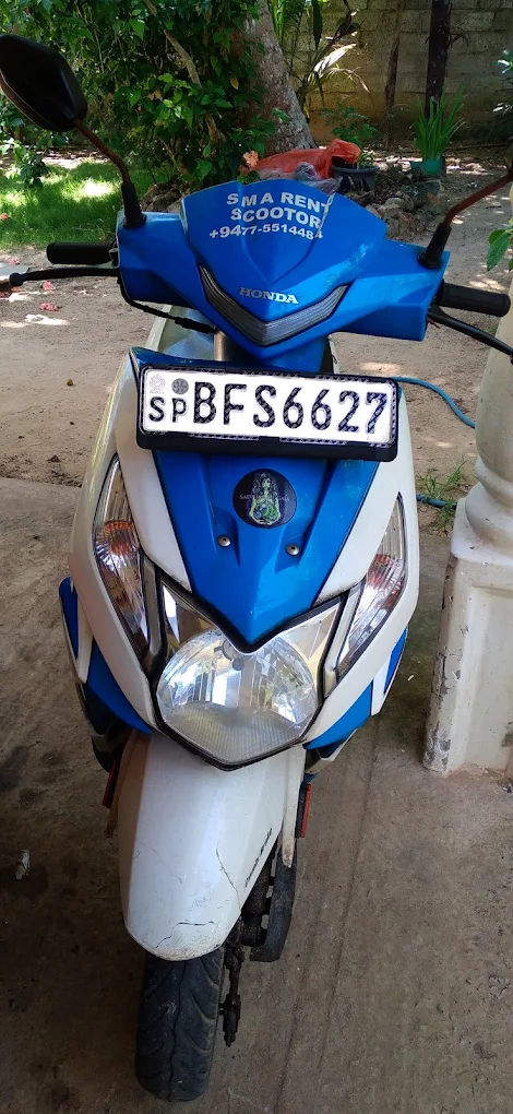 Blue and white Honda scooter with SMA branding